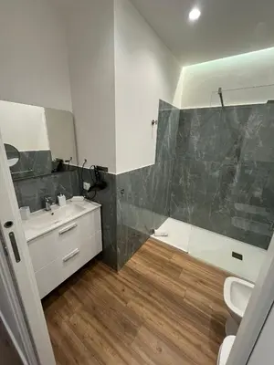 a bathroom with a sink and a shower and a toilet at Maison Butera in Palermo
