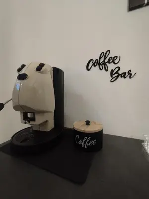a coffee shop with a coffee bar sign on a wall at Aria di Paese in Altavilla Milicia