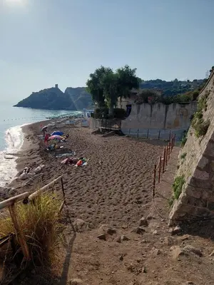 a group of people laying on a sandy beach at Aria di Paese in Altavilla Milicia