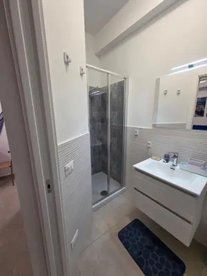 a bathroom with a sink and a shower at Francesca Holiday Home in Castellammare del Golfo