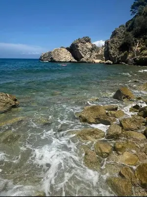 a beach with rocks and the ocean on a clear day at Francesca Holiday Home in Castellammare del Golfo