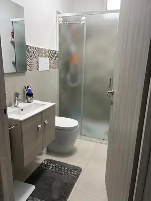 a bathroom with a shower and a toilet and a sink at Home Sicilia in Carini