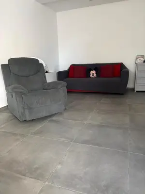 a couch and a chair in a living room at Home Sicilia in Carini