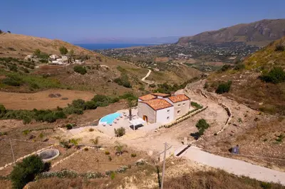 an aerial view of a house on a hill at Villa Baja Scopello in Balata di Baida