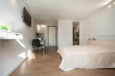 a bedroom with a bed and a table and a desk at Vicoloft al Capo in Palermo