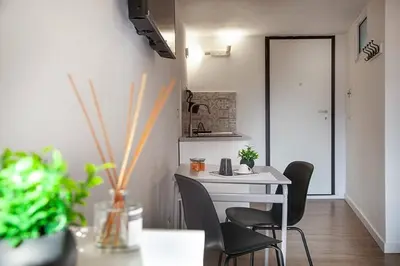 a room with a table and two chairs and a table at Vicoloft al Capo in Palermo