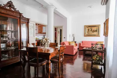 a living room with a table and a couch at High-end apartment in the city center in Palermo