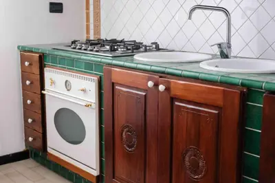 a kitchen with a stove and a sink at High-end apartment in the city center in Palermo