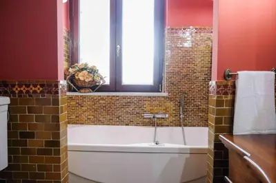 a bathroom with a bath tub and a window at High-end apartment in the city center in Palermo