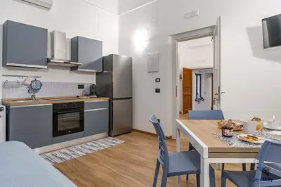 a kitchen and dining room with a table and chairs at Al Mondellu apt Verosicily in Palermo