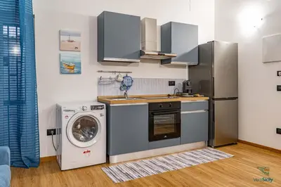 a kitchen with a washing machine and a washer at Al Mondellu apt Verosicily in Palermo