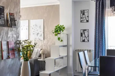 a living room with white furniture and plants on the wall at Sunny Suite Palermo in Palermo