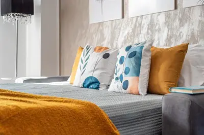 a bed with colorful pillows on top of it at Sunny Suite Palermo in Palermo
