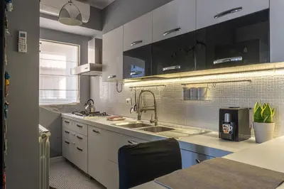 a kitchen with white cabinets and a sink at Sunny Suite Palermo in Palermo