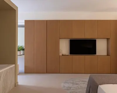 a living room with a flat screen tv in a wooden cabinet at Idro Luxury Suite in Palermo