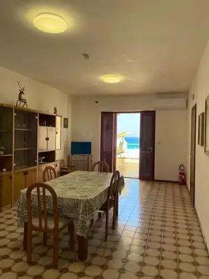 a dining room with a table and a view of the ocean at Sea view terrace house in Alcamo