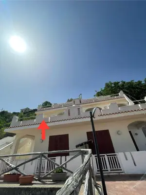 a house with a red arrow on top of it at Sea view terrace house in Alcamo