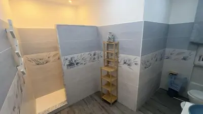 a bathroom with a toilet and a shelf in it at Vanila Dream's House in Palermo