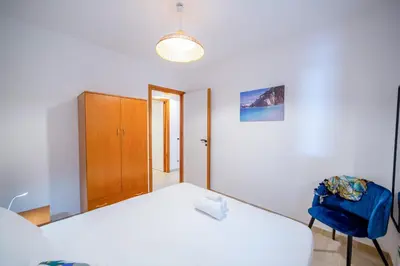 a kitchen with a stainless steel refrigerator and a sink at Marina Beach Apartments in Alcamo