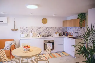 a kitchen with a table with a bowl of fruit on it at Marina Beach Apartments in Alcamo