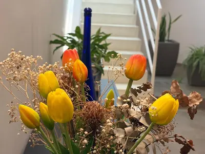 a vase filled with colorful flowers on a table at Nereide home 350 sqm with large garden in Balestrate