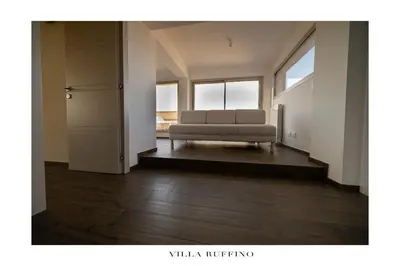a living room with a couch and some windows at Nereide home 350 sqm with large garden in Balestrate