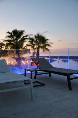 two picnic tables sitting on top of a patio at Hotel Tonnara Trabia in Trabia