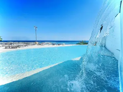a water fountain in front of a beach at Hotel Tonnara Trabia in Trabia