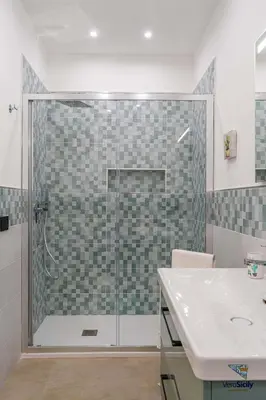 a bathroom with a toilet and a bidet and a sink at Ballaria in Palermo