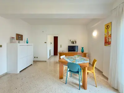 a room with a table and two chairs and a kitchen at Merlo Holiday Homes Attico in Palermo