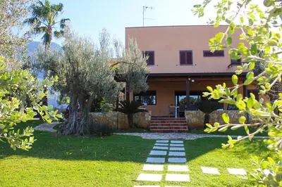 a house with a garden in front of it at Villa Adelaide in Cinisi