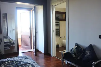 a living room with a couch and a door to a bathroom at Villa Adelaide in Cinisi