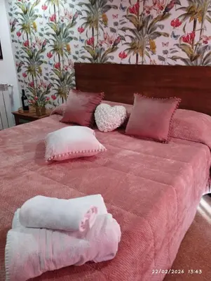 a pink bed with pink pillows on top of it at Nanà in Movida in Palermo