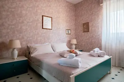 a bedroom with a bed with towels on it at Agelina square Home Gibellina in Nuova Gibellina