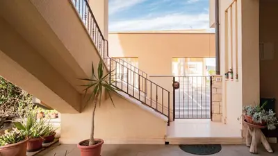 a staircase in a house with a potted plant at Agelina square Home Gibellina in Nuova Gibellina