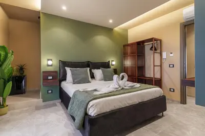 a bedroom with a large bed with towels on it at La Piazzetta Sea Rooms in Balestrate