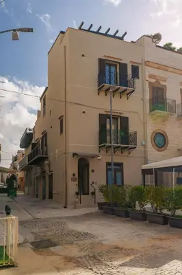 a building with balconies on the side of it at La Piazzetta Sea Rooms in Balestrate