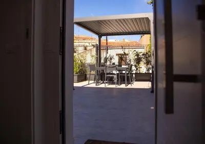 a view of a patio with a table and chairs at Solemar Sicilia - Casa Belle in Palermo