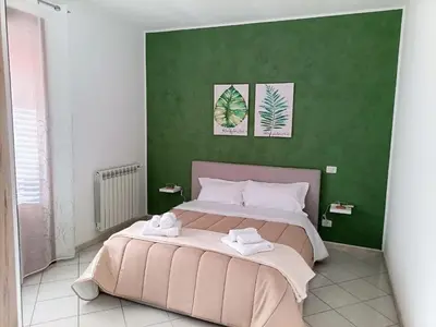 a bedroom with a large bed with two towels on it at La Capaciota in Capaci