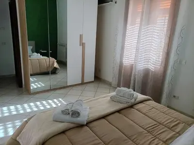 a bedroom with a bed with towels on it at La Capaciota in Capaci