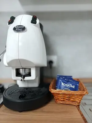 a white sewing machine sitting next to a basket at La Capaciota in Capaci