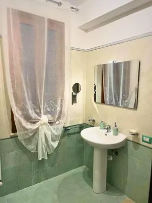 a bathroom with a sink and a mirror at La Capaciota in Capaci