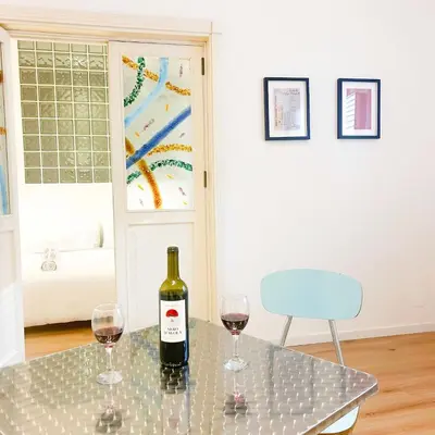 a bottle of wine sitting on a table with two glasses at Palazzo Crisafulli Suite in Palermo