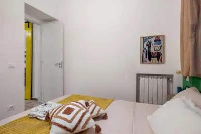 a bedroom with a bed with a stuffed animal on it at Carducci Apartment By DomuSicily in Palermo