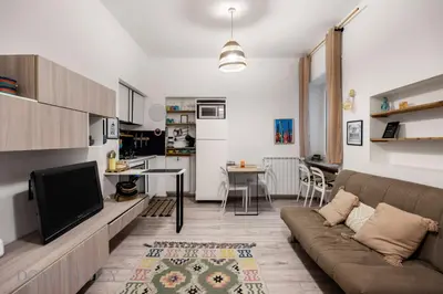 a living room with a couch and a tv at Carducci Apartment By DomuSicily in Palermo