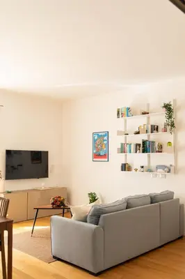 a living room with a couch and a tv at The Nest Maqueda in Palermo