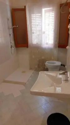a bathroom with a sink and a toilet and a shower at Casa degli Angeli Castellammare del Golfo TP Sicilia in Castellammare del Golfo