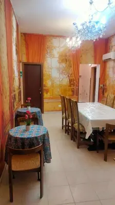 a dining room with a table and chairs and a chandelier at Casa degli Angeli Castellammare del Golfo TP Sicilia in Castellammare del Golfo