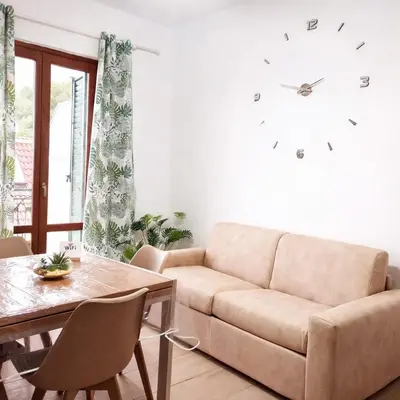 a kitchen with green cabinets and a wooden table at Blossom House in Isola delle Femmine