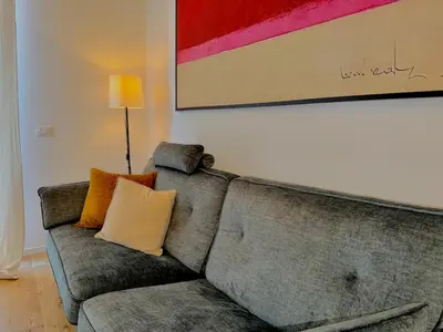 a couch in a living room with a painting at Haus Mignon - Bright flat in Palermo Center in Palermo